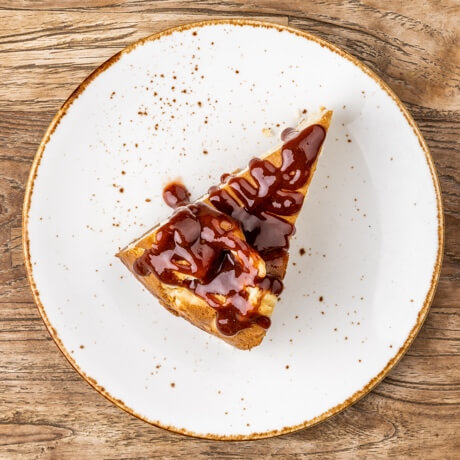 Homemade organic cheesecake with strawberry jam and Sichuan pepper